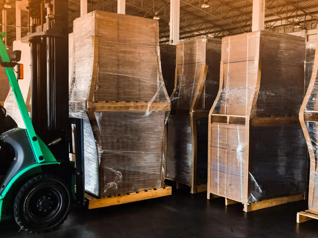 Poor warehouse efficiency illustrated by a congested warehouse staging area with palletized inventory awaiting put-away, highlighting how material flow bottlenecks are often mistaken for insufficient warehouse space.