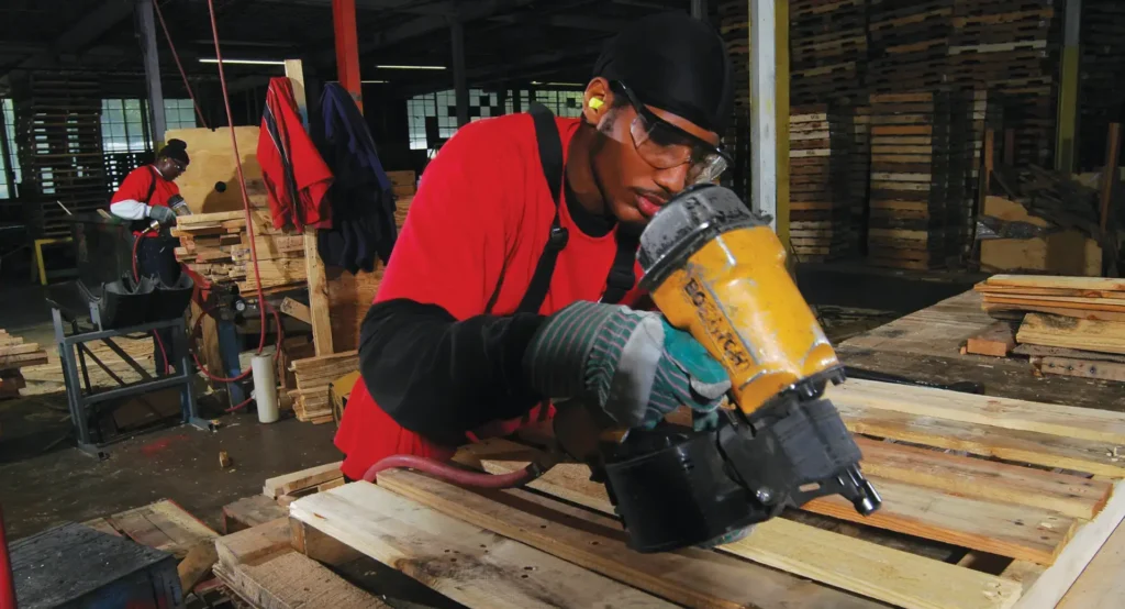 a picture of millwood team repairing a pallet inside a millwood repair facility