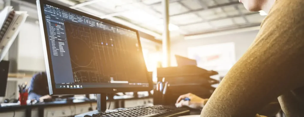 A picture an engineer working in front of a desktop computer