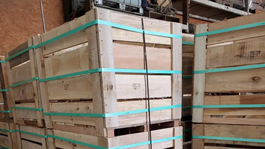 A wooden, wire-bound crate in a warehouse.
