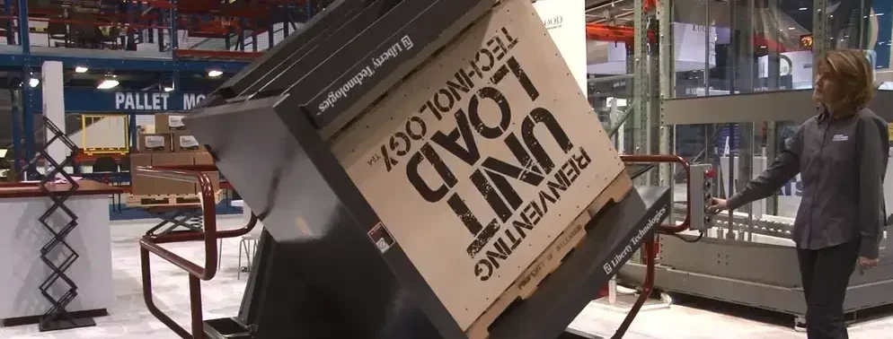 The Liberty Inverter, a machine that can pick up a plallet and its contents, and flip the contents upside down on to another pallet to reposition the contents in a clean and convenient manner