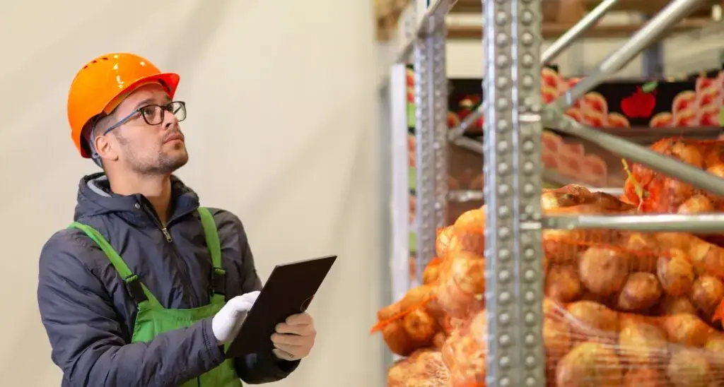 warehouse worker checking potatoes