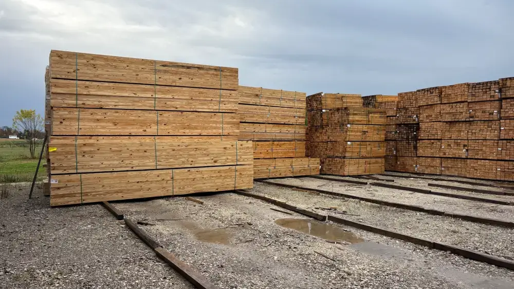 Stacks of Southern Yellow Pine sitting on a cement pad. This wood is a strong, durrable, versatile lumber choice.