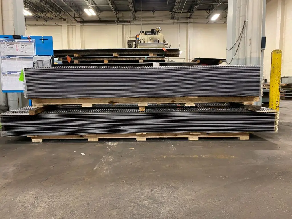 Long custom pallet designed to support and transport heavy steel platforms.