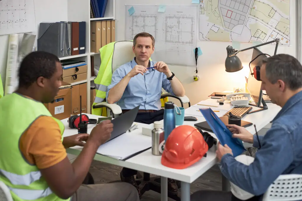 Procurement team reviewing costs to achieve savings through strategic sourcing and vendor consolidation.