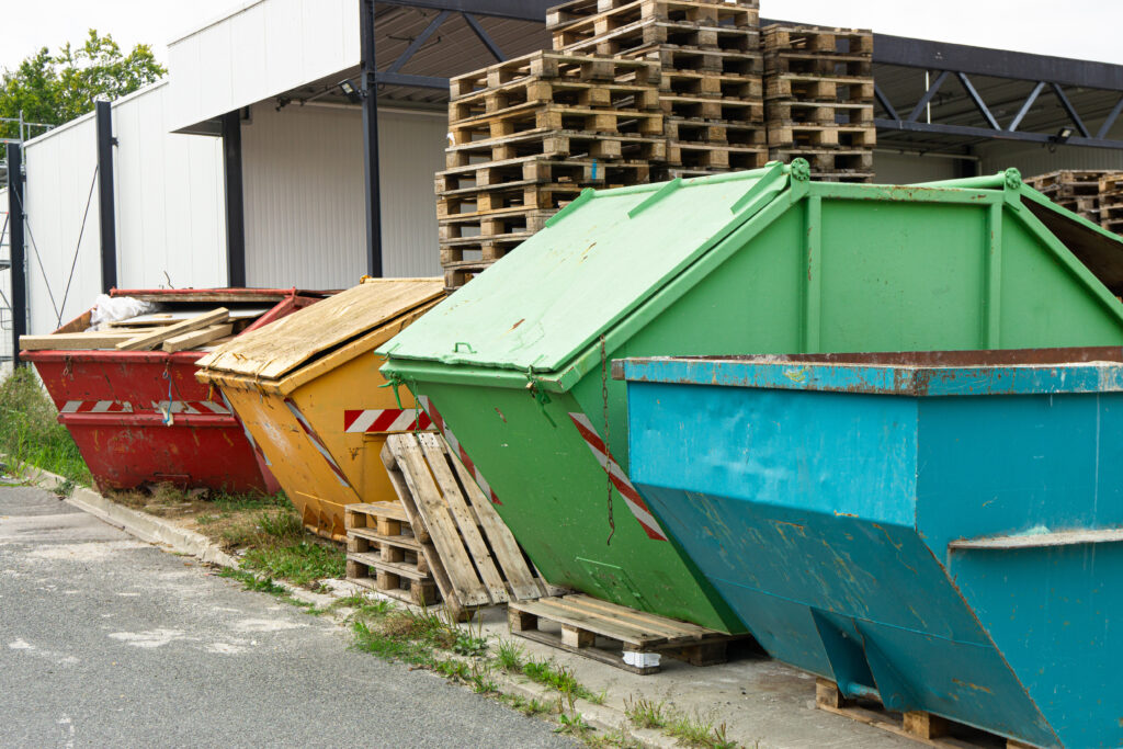 Broken pallets awaiting disposal after failing in a manufacturing operation due to improper pallet design and configuration.