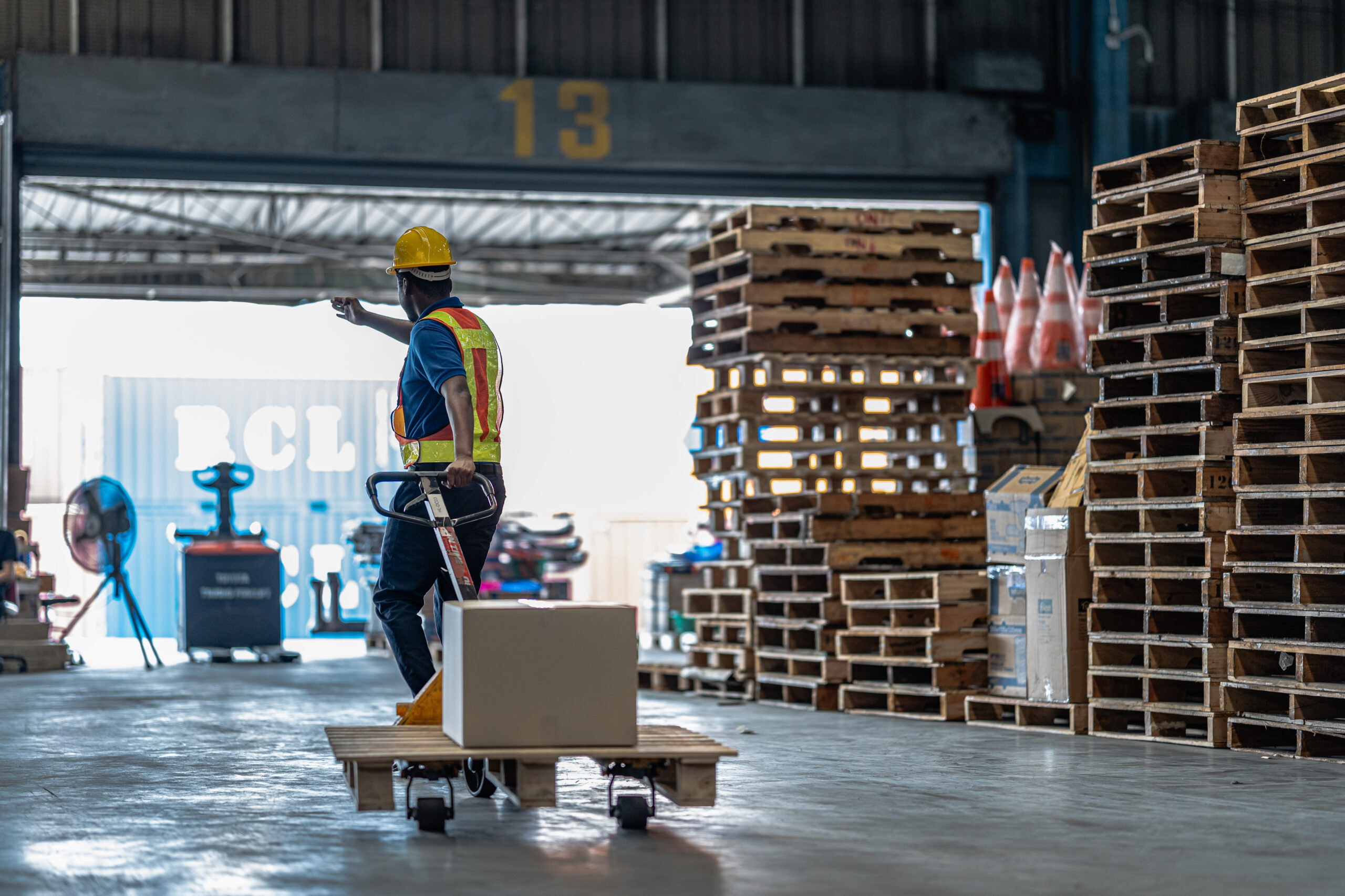 Organized rows of labeled wooden pallets in a manufacturing yard, reflecting a streamlined packaging procurement strategy