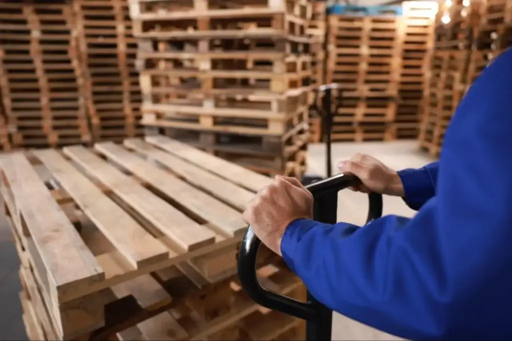 Pallet terminology guide featured image showing parts of a pallet including deck boards and stringer structure in a professional warehouse environment.