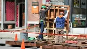 Two Team Members have been called in to handle the clean up of poor pallet safety as there is a wreckage on the street of pallets.