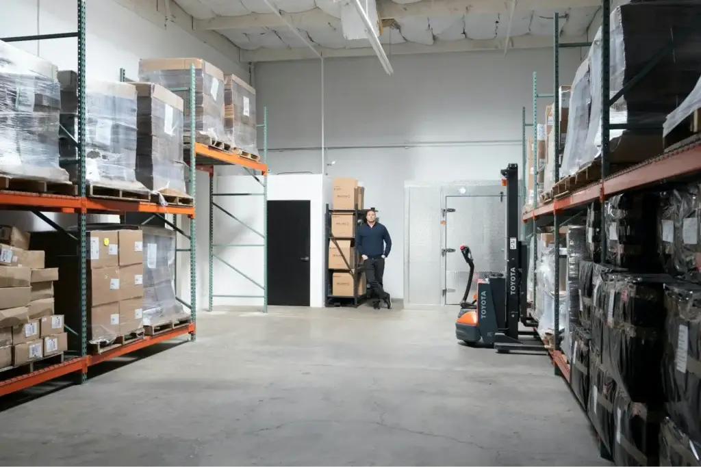  Millwood Team Member enjoying safe pallet handling in a neat and tidy warehouse. 
