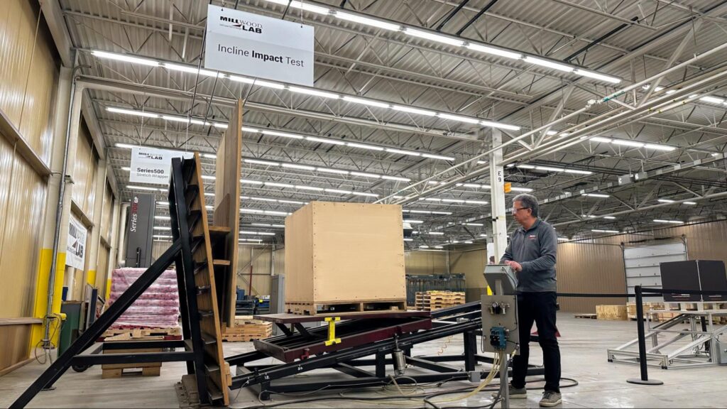 Millwood Packaging Science Team Member conducting impact and compression testing on a pallet designed for automated storage and retrieval systems