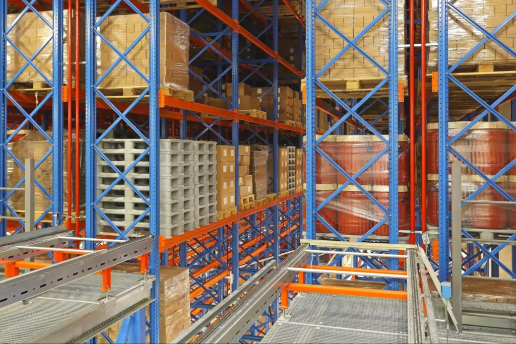 Automated racking system storing pallets in a high-density ASRS warehouse where dimensional precision prevents costly downtime.