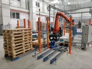 Robotic palletizer stacking product onto wood pallets inside an automated distribution center demonstrating supply chain automation in action.