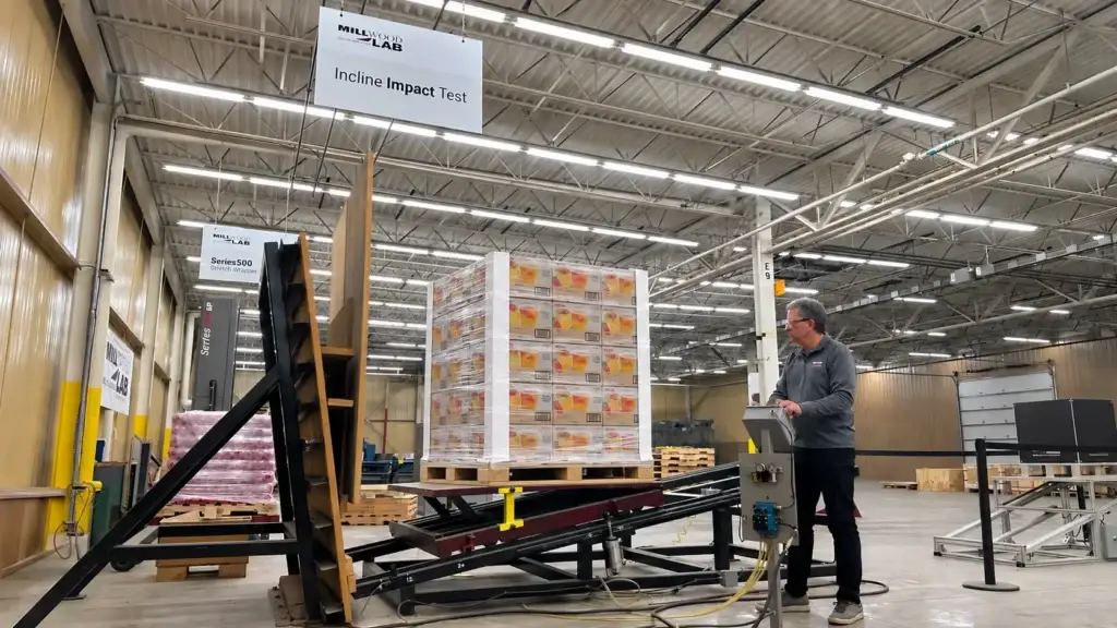 Packaging undergoing compression testing in an ISTA-certified lab, ensuring quality control and compliance for food and beverage supply chain operations.